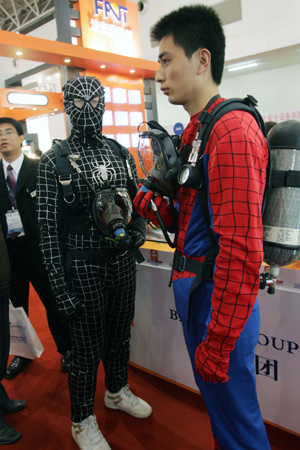 Two workers of an enterprise wear the clothes of "spider man" to attract visitors on an international fire protection exposition in Beijing, capital of China, Oct. 28, 2008. The 12th International Fire Protection Equipment, Technology Conference and Exposition was opened at the National Agriculture Exhibition Center in Beijing on Tuesday with participation of some 400 enterprises from more than 20 countries and regions. 