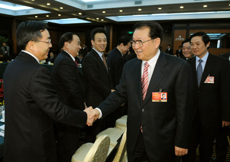 Chinese leaders joined deputies to the National People's Congress (NPC), the country's top legislature, in deliberating the government work report by Premier Wen Jiabao Thursday, calling for concerted efforts to overcome difficulties and achieve fresh development.