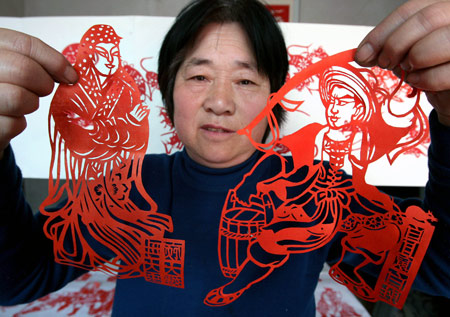 Folk artist Wang Zhenzhu displays her paper-cuttings of 108 generals of Chinese classic novel