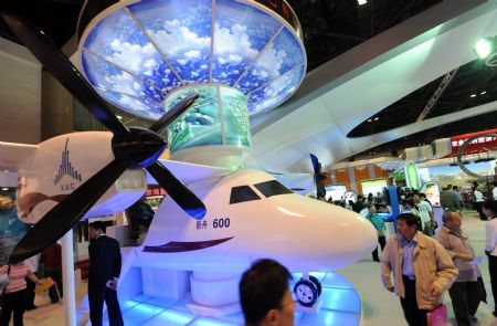 Audience visit a model of Xinzhou 600 aircraft developed by China Aviation Industry Corporation I (AVIC I) at an exhibition showcasing the achievements New China has made in the past six decades in Beijing, China, Sept. 20, 2009. The exhibition that opened on Saturday attracted lots of people. (Xinhua/Jin Liangkuai)