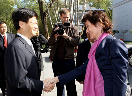 China's Public Security Minister Meng Jianzhu (L, front) shakes hands with visiting Eveline Widmer-Schlumpf, head of Federal Department of Justice and Police of Federal Council of Switzerland, in Beijing, capital of China, Oct. 26, 2009. 