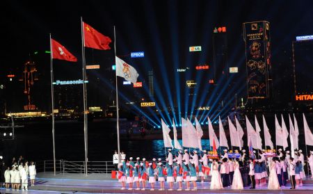 China's national flag and the flag of China's Hong Kong Special Administrative Region are raised during the opening ceremony of the 2009 East Asian Games in Hong Kong, south China, Dec. 5, 2009. (Xinhua File Photo)