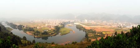 Photo taken on Sept 24, 2009 shows the panorama of Libo County in southwest China's Guizhou Province. The Karsts in southern China extends over a surface of half a million square kilometers lying mainly in Yunnan, Guizhou and Guangxi Provinces. The cone and tower karsts of Libo, also considered the world reference site for these types of karsts, form a distinctive and beautiful landscape. Wulong Karst has been inscribed for its giant dolines, natural bridges and caves. Libo County, together with the stone forest in Yunnan province and Wulong county in Chongqing city were inscribed on UNESCO's World Heritage List in 2007.(Xinhua/Liu Xu)