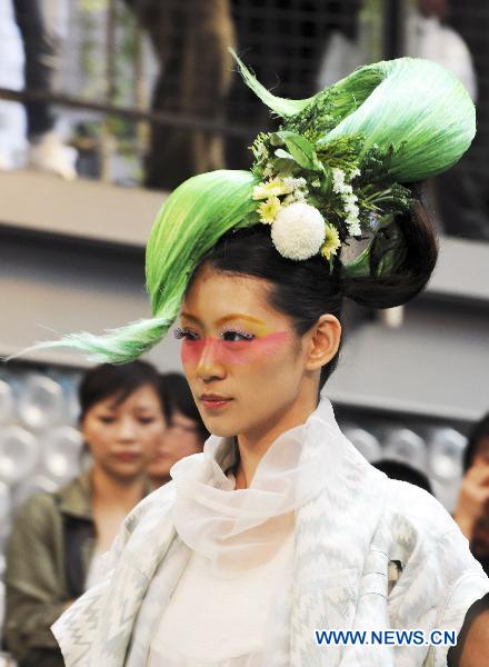 A model presents a hairstyle creation during a hairstyle show held in the A model presents a hairstyle creation during a hairstyle show held in the