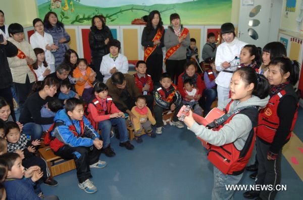 The volunteer band Angels play for brain paralyzed children in a rehabilitation center in Jinan, capital of east China's Shandong Province, Feb. 19, 2011. Local volunteers came and played for paralyzed children regularly since they set up a band called Angels in last May.  (Xinhua/Guo Xulei) (cxy) 
