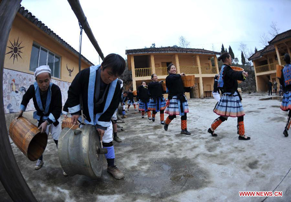 Villagers of the Baikuyao Nationality Eco-villages perform copper-drum dance in Huaili village of Lihu Yao autonomous township of Nandan county in Hechi city, southwest China's Guangxi Zhuang autonomous region, March 7, 2012. 