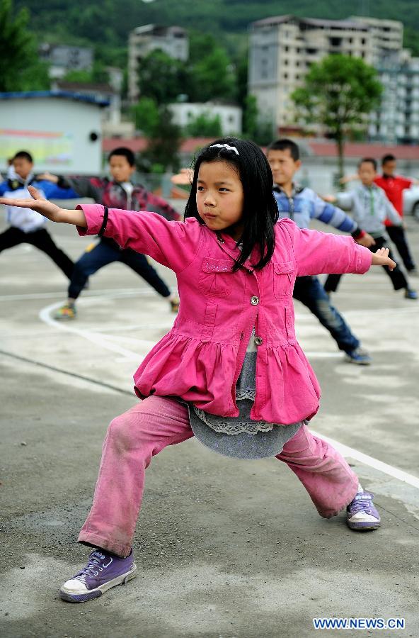A young girl practises Kung Fu, traditional Chinese martial arts, at the Baota Primary School in Xuan'en County, Enshi Tujia and Miao Autonomous Prefecture, central China's Hubei Province, May 14, 2012. 