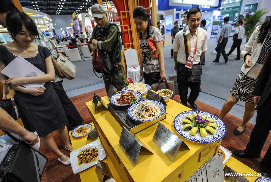 Visitors look at Sichuan cuisines displayed at the first China Beijing International Fair for Trade in Services (CIFTIS) in Beijing, capital of China, May 29, 2012. Opening Monday in Beijing, the CIFTIS attracted exhibitors of various Chinese cuisines, including the best-known Sichuan, Shandong, Guangdong and Huaiyang cuisines. 