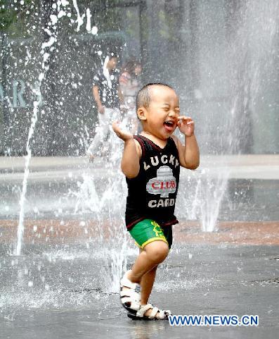 A little boy cools off at a fountain in Shenyang, capital of northeast China's Liaoning Province, Aug. 5, 2011. The city is experiencing a hot summer, with the highest temperature reaching 31 degrees Centigrade on Friday. (Xinhua/Yang Qing)