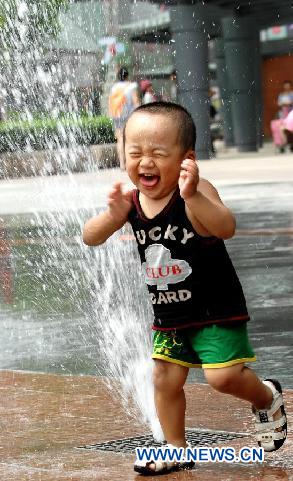 A little boy cools off at a fountain in Shenyang, capital of northeast China's Liaoning Province, Aug. 5, 2011. The city is experiencing a hot summer, with the highest temperature reaching 31 degrees Centigrade on Friday. (Xinhua/Yang Qing) 